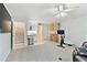 Spacious living room with access to kitchen, stairs, tile flooring, neutral carpeting and plenty of natural light at 9812 Indian Key Trl # 84, Seminole, FL 33776