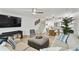 Spacious living room featuring modern furnishings, hardwood floors, and a contemporary staircase at 9812 Indian Key Trl # 84, Seminole, FL 33776