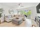 A bright living room with a comfortable sectional sofa, balcony access, and modern decor at 9812 Indian Key Trl # 84, Seminole, FL 33776