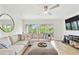 Bright living room with a comfortable sectional sofa, balcony access, and modern decor at 9812 Indian Key Trl # 84, Seminole, FL 33776