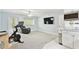 Sunlit living area with sleek fitness equipment, a comfortable recliner, and a modern entertainment setup at 9812 Indian Key Trl # 84, Seminole, FL 33776