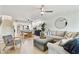 An open living space with a staircase, kitchen, dining area, and comfortable sectional sofa at 9812 Indian Key Trl # 84, Seminole, FL 33776