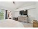 Spacious bedroom with a TV, balcony access, and walk-in closet at 9812 Indian Key Trl # 84, Seminole, FL 33776