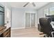 This office has hardwood floors, a ceiling fan, a sliding door, and a light blue wall at 9812 Indian Key Trl # 84, Seminole, FL 33776
