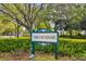 Community sign amidst lush foliage at 9812 Indian Key Trl # 84, Seminole, FL 33776