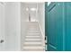 Bright foyer staircase with white stairs, handrail, a modern aesthetic, and an inviting ambiance at 9812 Indian Key Trl # 84, Seminole, FL 33776