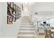 Stylish staircase with open design, adjacent to a modern kitchen with an island and ample lighting at 9812 Indian Key Trl # 84, Seminole, FL 33776