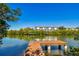 Water view of a calm canal and community docks, with clear blue skies at 9812 Indian Key Trl # 84, Seminole, FL 33776