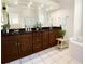 Bright bathroom featuring double vanity, granite countertops, and separate tub at 9912 Chris Craft Ct, Tampa, FL 33615