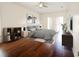 Bright bedroom with modern gray decor, hardwood floors, and a sliding glass door at 9912 Chris Craft Ct, Tampa, FL 33615