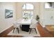 Bright dining room with large window, modern table, and hardwood floors at 9912 Chris Craft Ct, Tampa, FL 33615