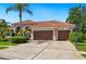 Lovely single-story home with clay tile roofing and a spacious driveway with basketball hoop at 9912 Chris Craft Ct, Tampa, FL 33615