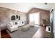 Bright living room with vaulted ceiling, brick accent wall, and modern neutral furniture at 9912 Chris Craft Ct, Tampa, FL 33615