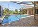 Spacious screened-in pool area with brick pavers and ample room for lounging and entertainment at 9912 Chris Craft Ct, Tampa, FL 33615