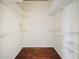 Spacious walk-in closet featuring hardwood floors and shelving for optimal storage at 9912 Chris Craft Ct, Tampa, FL 33615