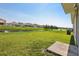Expansive backyard showcasing a serene water view, lush greenery, and a well-maintained lawn at 10326 Boggy Moss Dr, Riverview, FL 33578