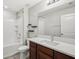 Clean bathroom featuring a vanity with white countertops, a large mirror, and a shower-tub combo at 10326 Boggy Moss Dr, Riverview, FL 33578