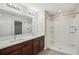 Bright bathroom featuring a double sink vanity with a step-in shower, and a neutral color palette at 10326 Boggy Moss Dr, Riverview, FL 33578