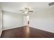 This bright bedroom has wood floors, a ceiling fan, and doorway leading to the bathroom at 10326 Boggy Moss Dr, Riverview, FL 33578
