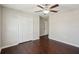 This bright bedroom has wood floors, a closet, and ceiling fan for added comfort at 10326 Boggy Moss Dr, Riverview, FL 33578