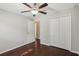 Bright bedroom featuring hardwood floors, double door closet and ceiling fan at 10326 Boggy Moss Dr, Riverview, FL 33578