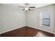 Neutral bedroom with hardwood floors and a ceiling fan at 10326 Boggy Moss Dr, Riverview, FL 33578