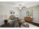 Staged bedroom showcasing a well-lit room with window, hardwood floors, and stylish decor at 10326 Boggy Moss Dr, Riverview, FL 33578