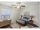 Stylishly furnished bedroom with a dresser, hardwood floors and a bed at 10326 Boggy Moss Dr, Riverview, FL 33578