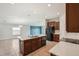 Open kitchen and living area with granite countertops, island sink, and black appliances at 10326 Boggy Moss Dr, Riverview, FL 33578
