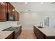 Bright kitchen with stainless steel appliances, white countertops, and dark wood cabinets at 10326 Boggy Moss Dr, Riverview, FL 33578