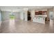 Open-concept living area with tile flooring, a sliding glass door and a modern kitchen at 10326 Boggy Moss Dr, Riverview, FL 33578