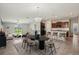 Staged living and dining area featuring a chandelier, modern furniture, and neutral color palette at 10326 Boggy Moss Dr, Riverview, FL 33578