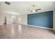 Large living room featuring tile floors and a blue accent wall at 10326 Boggy Moss Dr, Riverview, FL 33578