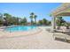 Community pool area featuring comfortable seating, lush landscaping, and a resort-like atmosphere at 10326 Boggy Moss Dr, Riverview, FL 33578