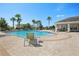 Beautiful community pool area with palm trees, comfortable lounge chairs, and inviting clear blue water at 10326 Boggy Moss Dr, Riverview, FL 33578