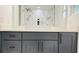 This bathroom features a gray vanity, light countertop, and shower with marble-style tile surround at 10406 N Boulevard, Tampa, FL 33612