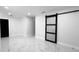 Minimalist bedroom design with a sliding door, marble floors, recessed lighting, and neutral colors at 10406 N Boulevard, Tampa, FL 33612