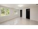 Bright bedroom featuring pristine white walls, modern marble floors, and large windows with a beautiful outdoor view at 10406 N Boulevard, Tampa, FL 33612