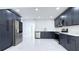 Well-equipped kitchen with stainless steel appliances, marble backsplash, and elegant blue cabinets at 10406 N Boulevard, Tampa, FL 33612