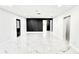 Stylish living room with marble floors, a modern accent wall, and a seamless flow into the kitchen area at 10406 N Boulevard, Tampa, FL 33612