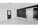 Spacious living room featuring a modern accent wall and sleek marble flooring at 10406 N Boulevard, Tampa, FL 33612