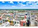Bright aerial view of a colorful building complex with a rooftop pool and lush landscaping, showcasing urban living at 1120 E Kennedy Blvd # 1127, Tampa, FL 33602