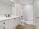 A modern bathroom with white tile, a white vanity, and stone floors at 1120 E Kennedy Blvd # 1127, Tampa, FL 33602