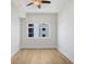 An empty bedroom with wood floors, a window, and a ceiling fan at 1120 E Kennedy Blvd # 1127, Tampa, FL 33602