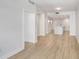 A hallway with wood floors leading to a kitchen with a white island at 1120 E Kennedy Blvd # 1127, Tampa, FL 33602