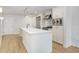 A modern kitchen featuring a white island, stainless steel appliances, and light wood floors at 1120 E Kennedy Blvd # 1127, Tampa, FL 33602