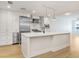 A modern kitchen featuring a white island, stainless steel appliances, and light wood floors at 1120 E Kennedy Blvd # 1127, Tampa, FL 33602