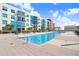 An outdoor pool surrounded by a multi-story apartment complex on a sunny day at 1120 E Kennedy Blvd # 1127, Tampa, FL 33602