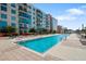 Sparkling swimming pool with clear blue water, surrounded by comfortable lounge chairs and tables for relaxation at 1120 E Kennedy Blvd # 1127, Tampa, FL 33602