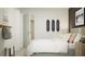 Bright bedroom featuring a comfortable bed, stylish nightstands, and fun skateboard-themed wall décor for a modern aesthetic at 11732 Brae Way, Dade City, FL 33525